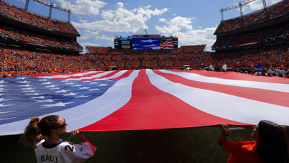 The American flag is displayed during an NFL football game between the Denver Broncos and the Kansas City Chiefs, Sunday, Sept. 14, 2014, in Denver. (AP Photo/Jack Dempsey)