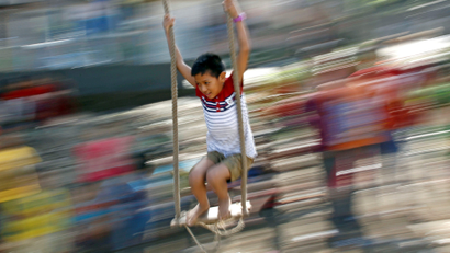 A boy plays on a traditional swing during Dashain, the biggest religious festival for Hindus in Nepal, in Kathmandu