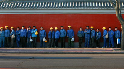 **FILE** In this April 8, 2007 file photo, Chinese migrant workers, who make the bulk of the work force in construction sites in cities across China, queue as they get ready for work in Beijing, China. An estimated 20 million migrant workers have lost jobs because of the global economic crisis, a government official said Monday, Feb. 2, 2009, giving the government a huge worry as it tries to maintain social stability. (AP Photo/Elizabeth Dalziel