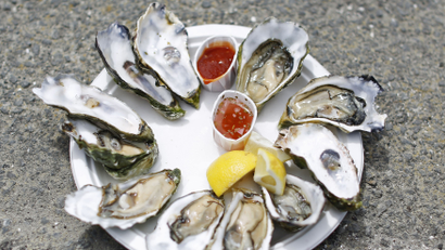 A plate of oysters is seen at Drakes Bay Oyster Company in Inverness, California July 31, 2014. The third-generation, family-owned oyster farm will be forced to shut its oyster shack and cannery on July 31 after losing a 19 month legal battle with the federal government. The Department of the Interior declined to renew the farm's lease in efforts to restore the area, also known as Drakes Estero within the Point Reyes National Seashore, to a state of marine wilderness as designated by the U.S. Congress in 1976. The case was denied an appeal by the U.S. Supreme Court on June 30 which upheld a decision by the 9th U.S. Circuit Court of Appeals to rule against the oyster company. However, the farm's harvesting operations will be permitted to continue for at least another 30 days after a group of local restaurants and businesses filed a new lawsuit and forged an agreement with the National Park Service to allow it to harvest until the court's ruling on the injunction. REUTERS/Stephen Lam