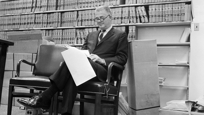 Special Watergate prosecutor Archibald Cox sits in his Washington office as he reads U.S. District Judge John Sirica's order that President Nixon produce tapes of the White House conversations on Watergate for private judicial inspection, Aug. 29, 1973.