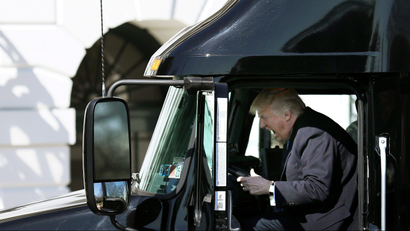 US President Donald Trump reacts as he sits on a truck while he welcomes truckers and CEOs to attend a meeting regarding healthcare at the White House in Washington, U.S., March 23, 2017.
