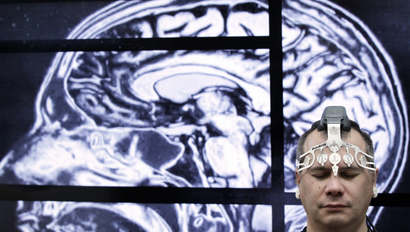 BrainScope employee Doug Oberly wears a brain scanning headset at the NFL owners' meeting in Boca Raton, Fla., Tuesday, March 22, 2016. The headset and mobile app can quickly and easily allow clinicians to determine whether patients have sustained a traumatic brain injury (TBI), the company says. (AP Photo/Luis M. Alvarez)