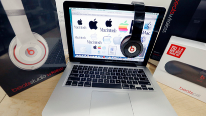 Apple laptop paired with Beats Electronics products