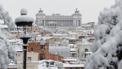 Roofs are seen covered in snow during a heavy snowfall in downtown Rome