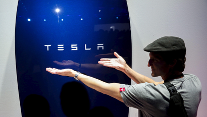Attendees take pictures of the new Tesla Energy Powerwall Home Battery during an event at Tesla Motors in Hawthorne, California April 30, 2015. Tesla Motors Inc unveiled Tesla Energy - a suite of batteries for homes, businesses and utilities - a highly-anticipated plan to expand its business beyond electric vehicles. REUTERS/Patrick T. Fallon - RTX1B28Q