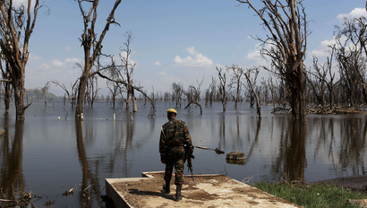 A park ranger surveys damage caused by flooding at Lake Nakuru National Park, Kenya, August 18, 2015. The Park is home to some of the world's most majestic wildlife including lions, rhinos, zebras and flamingos. The scenery is stunning, from forests of acacia trees to animals congregating at the shores to drink. UNESCO says that with rapid population growth nearby, the area is under "considerable threat from surrounding pressures," particularly deforestation, a contributing factor in floods.