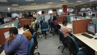 Employees work on floor of outsourcing company WNS in Mumbai