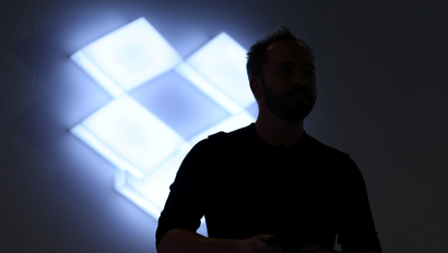 Drew Houston, Chief Executive Officer and founder of Dropbox, stands in front of the company's logo at an announcement event in San Francisco, California, U.S., January 30, 2017. REUTERS/Beck Diefenbach - RC12885F1140