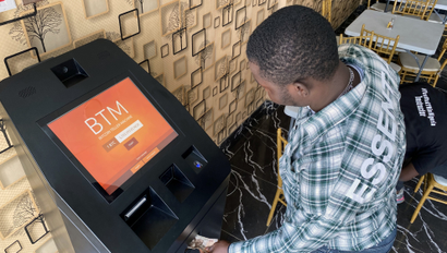 A man using a bitcoin ATM
