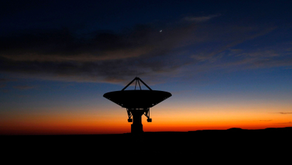 Dawn breaks over a radio telescope dish of the KAT-7 Array pointing skyward at the proposed South African site for the Square Kilometre Array (SKA) telescope near Carnavon in the country's remote Northern Cape province in this picture taken May 18, 2012. South Africa is bidding against Australia to host the SKA, which will be the world's largest radio telescope when completed. Picture taken May 18, 2012.