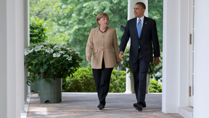President Barack Obama and German Chancellor Angela Merkel take a walk