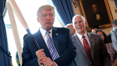 Vice President Mike Pence laughs as U.S. President Donald Trump holds a baseball bat as they attend a Made in America product showcase event at the White House in Washington, U.S., July 17, 2017. REUTERS/Carlos Barria TPX IMAGES OF THE DAY - RC17A27D6E30
