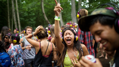 Revelers dance at the silent disco during the Firefly Music Festival in Dover