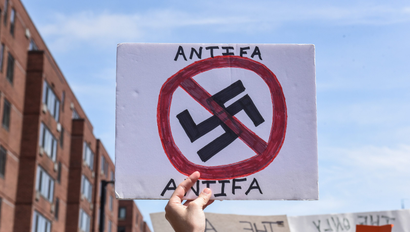 A counter protester holds a sign with the words "Antifa" (anti-fascists) outside of the Boston Commons and the Boston Free Speech Rally in Boston, Massachusetts