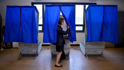 File photo of a voter leaving the booth after casting her ballot in the Pennsylvania primary at a polling place in Philadelphia