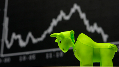 A bull styrofoam figure is pictured in front of the DAX board at the Frankfurt stock exchange