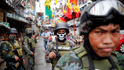 Armed security forces take a part in a drug raid, in Manila, Philippines