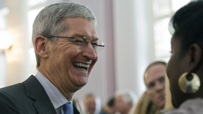 Apple chief executive and Alabama native Tim Cook laughs with a group before an Alabama Academy of Honor ceremony at the state Capitol in this Oct. 27, 2014 file photo taken in Montgomery, Ala
