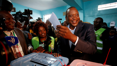 FILE PHOTO: Kenya's President Uhuru Kenyatta casts his ballot inside a polling station in his hometown of Gatundu in Kiambu county, Kenya August 8, 2017. To match Special Report KENYA-POLICE/WATCHDOG