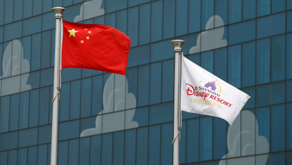 Chinese (L) and Disney flags are seen at Shanghai Disney Resort during a part of the three-day Grand Opening events in Shanghai, China, June 15, 2016.