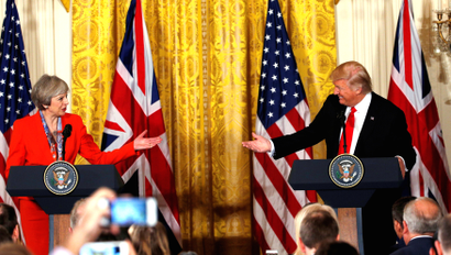 British Prime Minister Theresa May and U.S. President Donald Trump gesture towards each other during their joint news conference at the White House in Washington, U.S., January 27, 2017.
