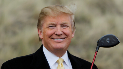Donald Trump holds a golf club