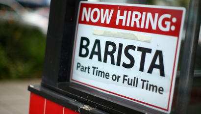 Hiring sign for a part-time or full-time barista on a restaurant window.