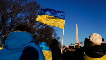 Blue and yellow Ukrainian flags in the air overcast by a blue sky