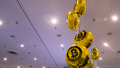 Bitcoin themed balloons float in the air during the "Inside Bitcoins: The Future of Virtual Currency Conference" in New York