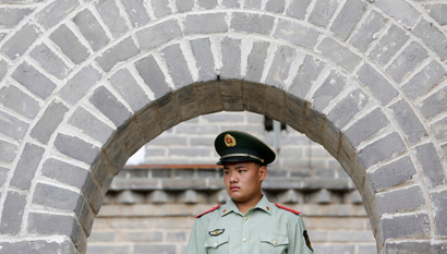 A paramilitary police officer stands guard before U.S. Secretary of State John Kerry and U.S. Treasury Secretary Jacob Lew arrive to tour the Badaling section of the Great Wall, on the outskirts of Beijing, July 8, 2014. The United States will press China to resume cooperation on fighting cyber espionage to ensure an orderly cyber environment, a senior U.S. official said on Tuesday ahead of annual talks between the world's two largest economies this week. REUTERS/Jason Lee (CHINA - Tags: POLITICS BUSINESS MILITARY) - RTR3XKRU
