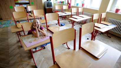 Primary school student Mia (7) smiles inside a classroom in an empty school, closed during a one-day strike by local teachers seeking higher salaries and better work conditions, in Bratislava September 13, 2012. Mia, along with other children whose parents were unable to take care of them during the strike on Wednesday, were placed in the care of volunteers who offered their services to take care of them. REUTERS/Radovan Stoklasa (SLOVAKIA - Tags: EDUCATION CIVIL UNREST BUSINESS EMPLOYMENT) - RTR37WZ5