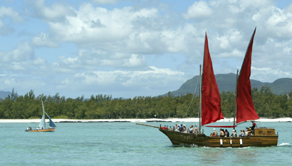 Two boats off the coast of Mauritius, including the replica of a pirate galleon.