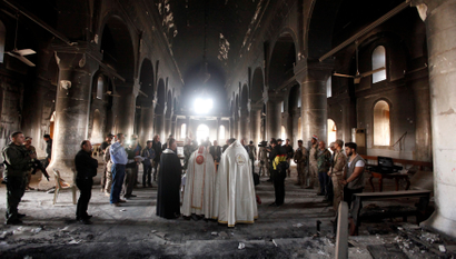 Iraqi priests hold the first mass at the Grand Immaculate Church since it was recaptured from Islamic State in Qaraqosh