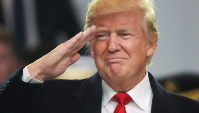U.S. President Donald Trump salutes participants during the inaugural parade