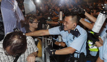 Police clash with protestors at a police barricade outside the Chinese government's headquarters in Hong Kong, China, 06 November 2016. Thousands of protestors marched through the streets of Hong Kong to protest against the Chinese government's controversial decision to decide the fate of two Hong Kong lawmakers who refused to pledge allegiance to the Hong Kong constitution and swore featly to the Hong Kong nation instead. EPA/ALEX HOFFORD