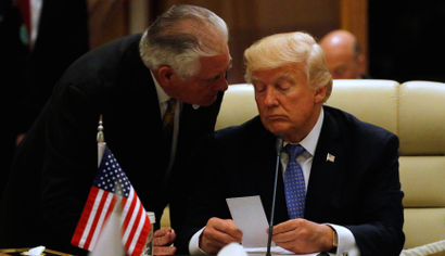 U.S. Secretary of State Rex Tillerson hands President Donald Trump a note, as Trump sits down to a meeting with of Gulf Cooperation Council leaders, during their summit in Riyadh, Saudi Arabia May 21, 2017.