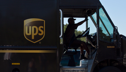 FILE - In this Sept. 23, 2014 file photo, a United Parcel Service (UPS) truck driver enters a company warehouse in Birmingham, Ala. UPS reports quarterly financial results before the market opens on Tuesday, Oct. 27, 2015. (AP Photo/Brynn Anderson, File)