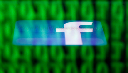 A Facebook logo on an Ipad is reflected among source code on the LCD screen of a computer, in this photo illustration taken in Sarajevo June 18, 2014. Ireland's High Court on Wednesday asked the European Court of Justice (ECJ) to review a European Union-U.S. data protection agreement in light of allegations that Facebook shared data from EU users with the U.S. National Security Agency. REUTERS/Dado Ruvic (BOSNIA AND HERZEGOVINA - Tags: CRIME LAW BUSINESS POLITICS) - RTR3UH6G