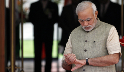 India's Prime Minister Narendra Modi looks at his watch