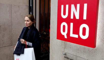 A customer leaves the casual clothing store Uniqlo operated by Japan's Fast Retailing in Paris, France October 24, 2016. REUTERS/Charles Platiau - D1BEUKDBFAAB