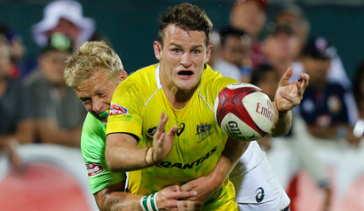 Australia's Con Foley is tackled by South Africa's Kyle Brown during their Sevens World Series final rugby match in Dubai December 6, 2014. REUTERS/Ahmed Jadallah (UNITED ARAB EMIRATES - Tags: SPORT RUGBY) - RTR4GYPL