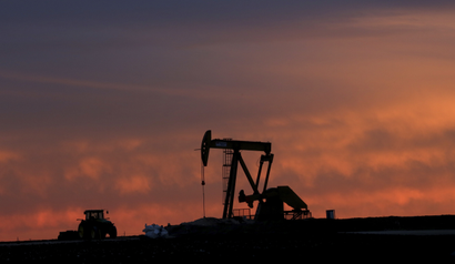 In this photo made Monday, Dec. 22, 2014, a well pump works at sunset on a farm near Sweetwater, Texas. At the heart of the Cline, a shale formation once thought to hold more oil than Saudi Arabia, Sweetwater is bracing for layoffs and budget cuts, anxious as oil prices fall and its largest investors pull back.