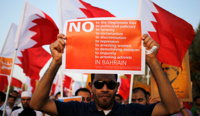 A protester holding an anti-government banner participates in a rally organised by Bahrain's main opposition party Al Wefaq in Budaiya August 8, 2014. REUTERS/Hamad I Mohammed (BAHRAIN - Tags: POLITICS CIVIL UNREST) - RTR41QHB