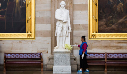 Maria Bernal de Navarrette cleans a statue of Alexander Hamilton, a Founding Father of the United States, in Rotunda on Capitol Hill in Washington October 15, 2013. Republicans in the House of Representatives failed to reach internal consensus on Tuesday on how to break an impasse on the federal budget that could soon result in an economically damaging default on the country's debt. REUTERS/Joshua Roberts (UNITED STATES - Tags: POLITICS BUSINESS EMPLOYMENT) - RTX14COM