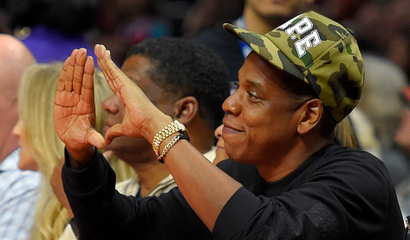 Rapper Jay-Z gestures during the first half of an NBA basketball game between the Los Angeles Clippers and the Cleveland Cavaliers, Friday, Jan. 16, 2015, in Los Angeles.