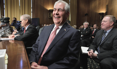 ExxonMobil chairman and CEO Rex Tillerson laughs as he takes his seat on Capitol Hill in Washington, Thursday, May 12, 2011, prior to testifying before the Senate Finance Committee hearing with top executives from the big oil companies on high gasoline prices and high profits.