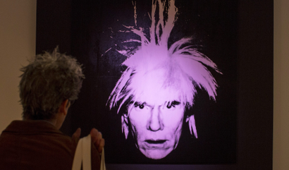 A man examines "Self-Portrait" by Andy Warhol during a media preview at Christie's auction house in New York, October 31, 2014. Christie's estimates its postwar and contemporary art auction will total more than $600 million, the highest pre-sale estimate ever for any single sale. REUTERS/Brendan McDermid (UNITED STATES - Tags: ENTERTAINMENT SOCIETY) - GM1EAB10BG701