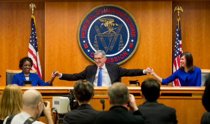 Federal Communication Commission (FCC) ChairmanTom Wheeler, center, joins hands with FCC Commissioners Mignon Clyburn, leaft, and Jessica Rosenworcel, before the start of their open hearing in Washington, Thursday, Feb. 26, 2015. Internet service providers like Comcast, Verizon, AT&amp;T, Sprint and T-Mobile would have to act in the "public interest" when providing a mobile connection to your home or phone, under new rules being considered by the Federal Communications Commission. The rules would put the Internet in the same regulatory camp as the telephone, banning providers from "unjust or unreasonable" business practices. (AP Photo/Pablo Martinez Monsivais)