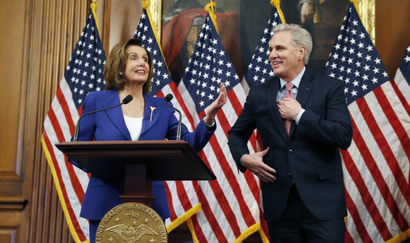 House Speaker Nancy Pelosi, a Democrat, and Rep. Kevin McCarthy, a Republican, participate in a bill enrollment ceremony for the Coronavirus Aid, Relief, and Economic Security (CARES) Act.